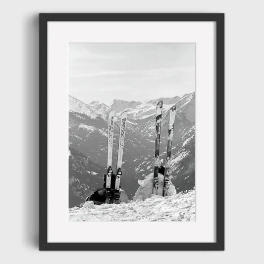 Skis Propped Up Against a Snowy Mountain Backdrop | Ready for the Slopes: Ski Equipment in the Alps | Vintage Ski Gear Posters