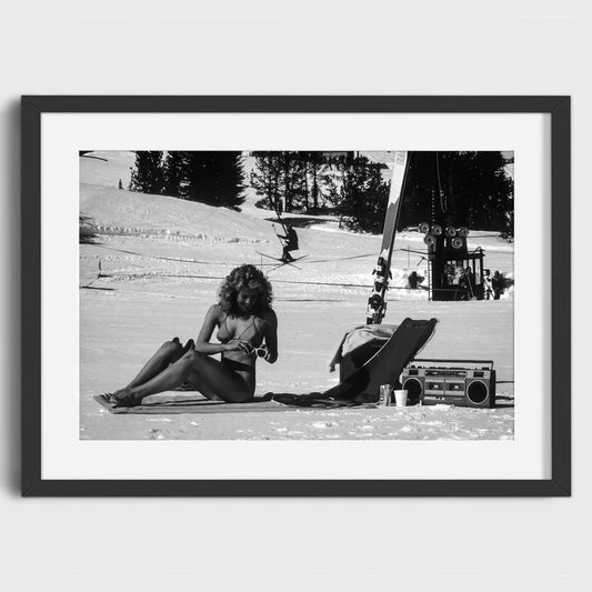 Woman Sunbathing on a Snowy Mountain | Sun & Snow: Bask in Unexpected Ski Resort Delights | Retro Ski Resort Posters